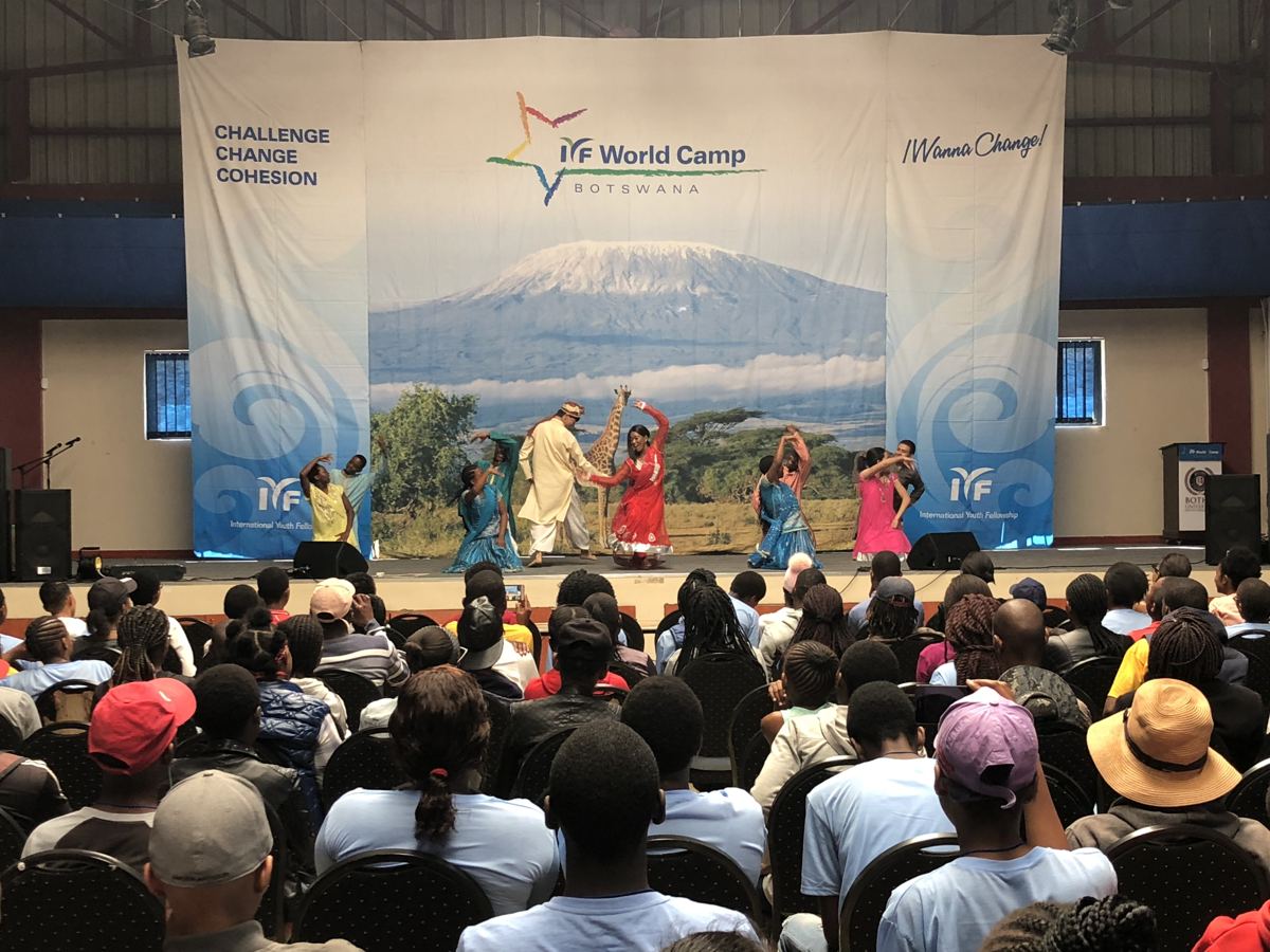 Performers in colourful traditional dress on stage.