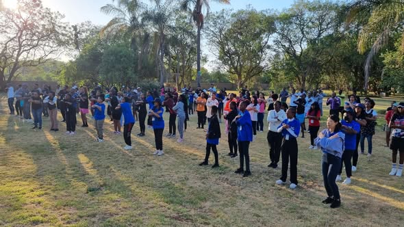 Youth practising a dance together outdoors.